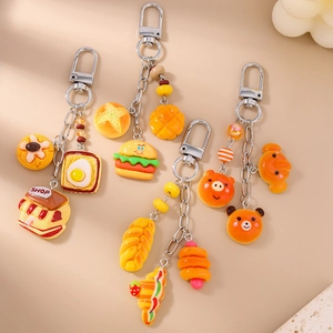 Close-up of food-themed keychains featuring simulation croissant and toast charms