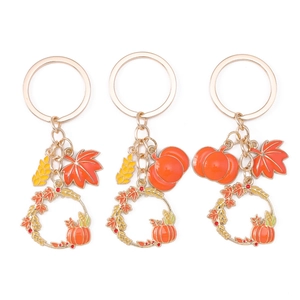 Autumn themed pumpkin and maple leaf keychain set with golden alloy finish
