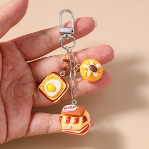 Detail of creative resin keychain featuring toasted egg bread and miniature shop charms