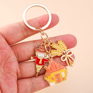 Fall scarecrow and maple leaf house keychain charm with golden wheat stalk pendant