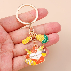 Detail of Thanksgiving enamel keychain with wheat, corn, and heart envelope charms