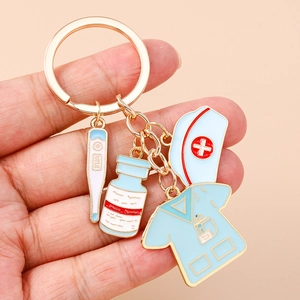 Close-up of a nurse-themed keychain with thermometer, medicine bottle, and uniform charms