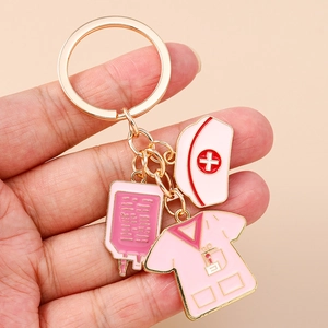 Nurse themed metal keychain with medical charms including pink nurse uniform and cap