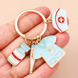 Detailed close-up of nurse theme keychain with enamel uniform and medical charms