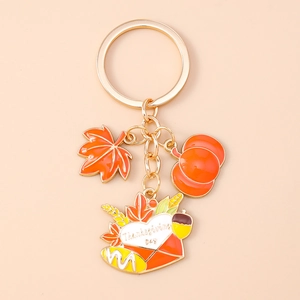 Detail of Thanksgiving keychain with maple leaf, pumpkin and Thanksgiving Day envelope charm