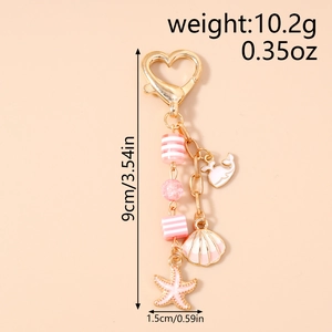 Pink ocean theme keychain featuring whale, starfish, and shell charms with size measurements