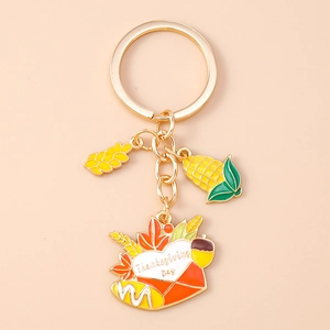 Detailed view of Thanksgiving keychain with corn, wheat, and maple leaf enamel charms