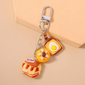 Detail of cute resin donut, bread and shop keychain charm with silver metal clasp