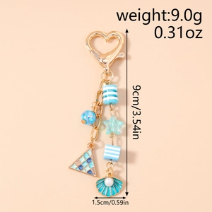 Macro detail of ocean-style keychain with seashell, starfish, and blue striped beads