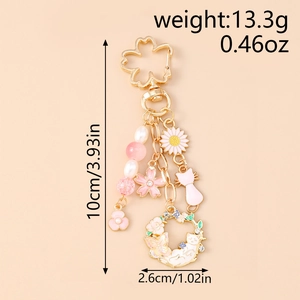 Detailed size view of floral rabbit keychain with pink enamel charms and golden clasp