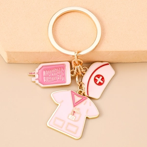 Detail of medical nurse keychain featuring pink blood bag and scrub top pendants