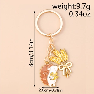 Detailed view of enamel hedgehog and wheat charm keychain with size and weight dimensions