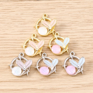 Detailed macro view of mermaid tail pendants with faux cat's eye gems for jewelry making