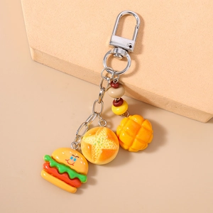 Detailed view of creative burger and bread food charms on a silver lobster clasp keychain