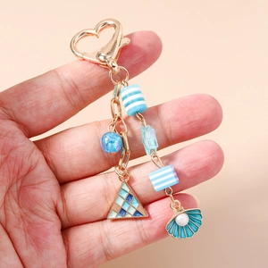 Marine theme keychain with blue seashell and starfish charms on heart lobster clasp