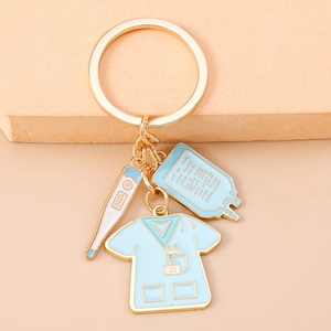 Detailed close-up of medical nurse keychain with scrubs and thermometer charms
