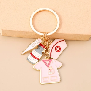 Detailed close-up of nurse theme keychain with pink medical charms in gold finish