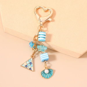 Ocean-themed keychain with sea shell pearl, blue starfish and golden lobster clasp