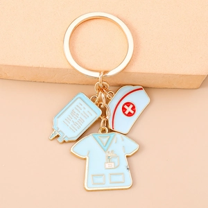 Close-up of nurse themed keychain with infusion bag and uniform pendants on golden chain