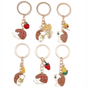 Chic hedgehog enamel keychain set with apple, strawberry and floral charms in gold finish