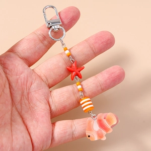 Starfish and clownfish beaded keychain with vibrant orange charms for bags and keys