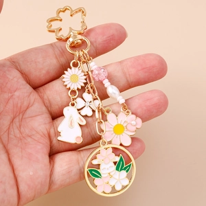 Floral bunny keychain with cherry blossom, daisy pendants and pink bead accessories