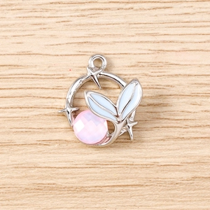 Close-up of pink gemstone star pendant with white enamel leaves for DIY jewelry making