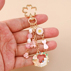 Japanese style cherry blossom keychain with floral cat wreath and pink daisy charm