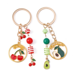 Enamel cherry and avocado fruit keychains with gold metal rings and striped beads