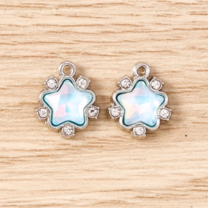 Macro detail of two star pendants with aurora crystals and silver metal plating for DIY jewelry