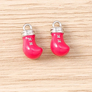 Pink boxing glove charms with silver stars for jewelry making on wooden background