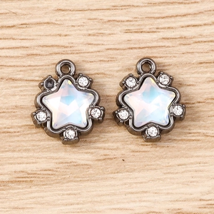 Detail of star-shaped pendants featuring iridescent opal and rhinestones with gunmetal frame