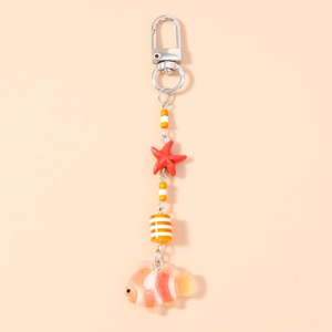 Close-up of a starfish and clownfish keychain pendant with orange beads and silver clasp