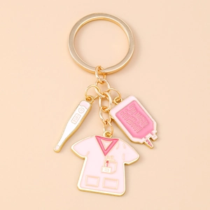 Detail of creative medical keychain with pink nurse uniform and thermometer charms