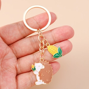 Cute hedgehog keychain with yellow corn charm in gold finish and enamel details
