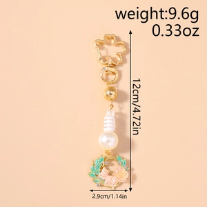 Detail of flower cat keychain with pink cat, yellow rose, and white pearl charm