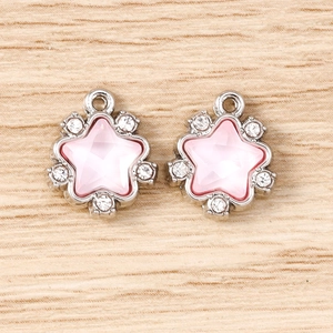 Detail of pink star pendants with silver base and crystal rhinestones for DIY jewelry