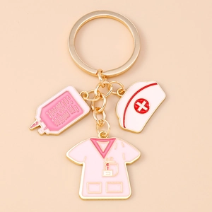 Detail of nurse theme keychain with pink IV bag, medical cap and uniform enamel charms