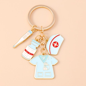Detail of medical keychain with nurse hat, thermometer, blue pill bottle and scrub top