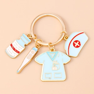Macro shot of nurse-themed keychain with enamel pill bottle and thermometer charms