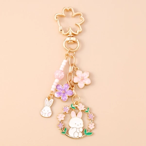 Detail of cherry blossom carabiner with enamel bunny charms and pink bead accents