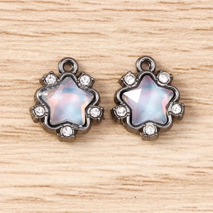 Macro shot of gun-black star charms with moonstone-effect glass and tiny rhinestones