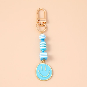 Detail of light blue beaded keychain with gold clasp and sky blue smiley face charm