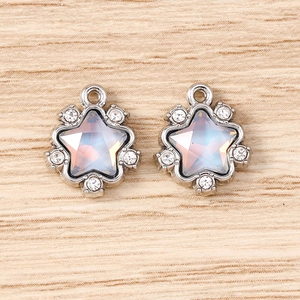 Detailed view of silver star charms with colorful rhinestones for jewelry making