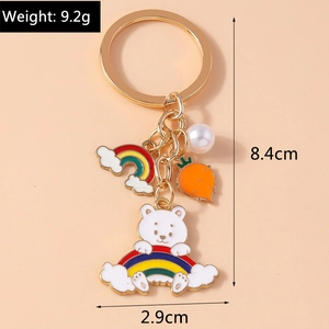 Detail view of rainbow bear keychain with carrot, pearl charms and size dimensions