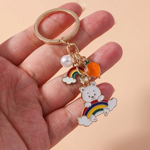 Cartoon rainbow bear keychain with gold ring, pearl, and carrot pendant charms