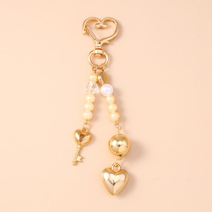 Golden heart-shaped keychain with elegant white pearls and a star-shaped crystal charm