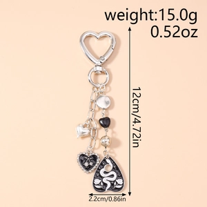 Detail showing dimensions of gothic heart keychain with snake pattern and rhinestones
