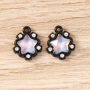 Macro view of star-shaped pendants with opal-like stones and sparkling small rhinestones