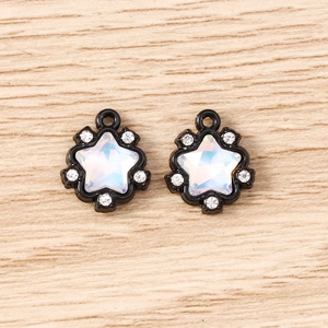 Macro detail of black alloy star pendants with iridescent AB crystal and white rhinestones